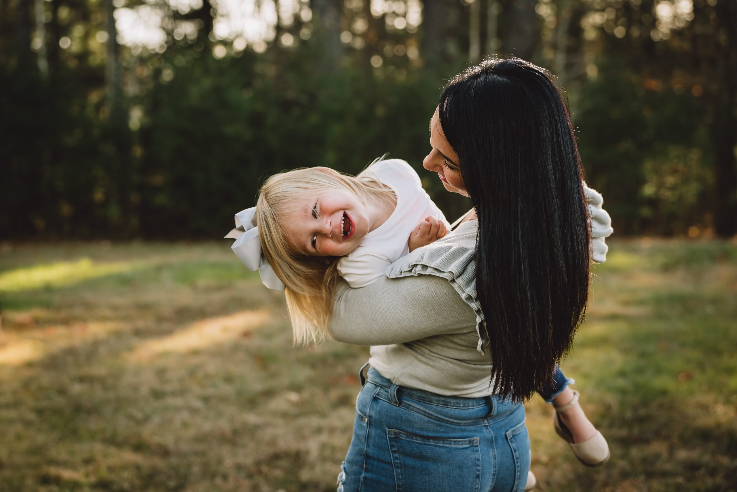 Mother and daughter laughing during a family session